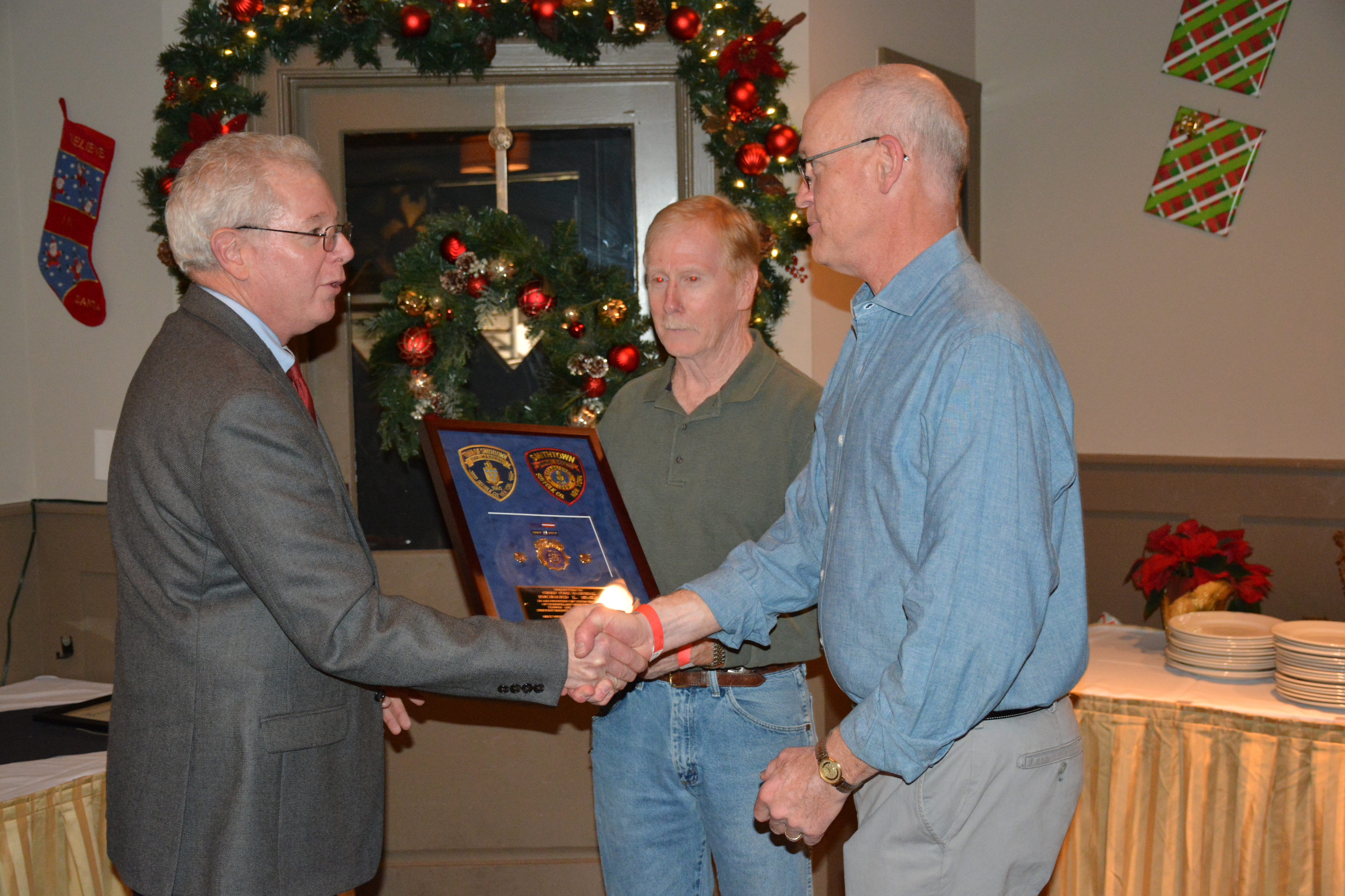 Chief John Valentine, Director of the Town of Smithtown Department of Public Safety congratulates Chief Fire Marshal Richard McKay after presenting him with his retirement plaque.